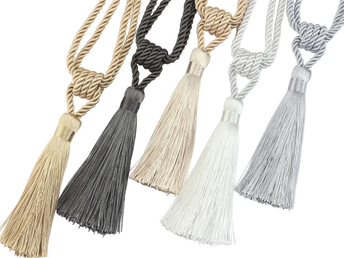 Elegant curtain tiebacks with tassels in various neutral tones like beige, gray, and black.