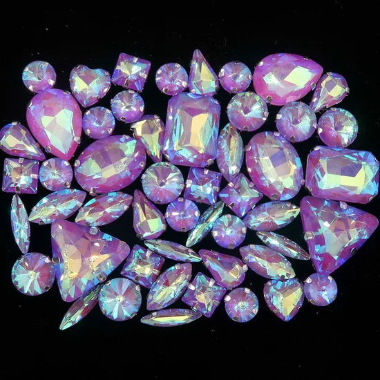 A collection of pink and purple faceted rhinestones arranged in a decorative pattern.