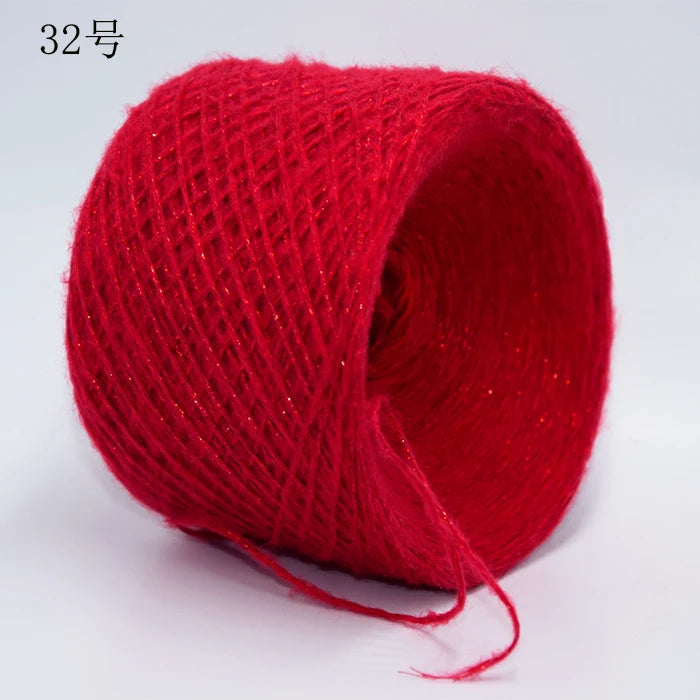 A spool of bright red metallic merino wool yarn for hand knitting