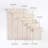 A set of ten natural beige cotton drawstring gift bags displayed in a vertical arrangement.