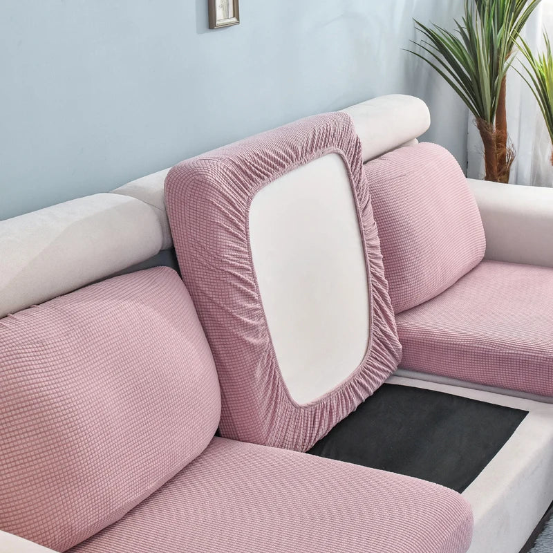 Pink stretch sofa seat cushion protector slipcover with a white rectangular insert