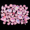 A collection of pink and iridescent faceted rhinestones arranged on a dark background.