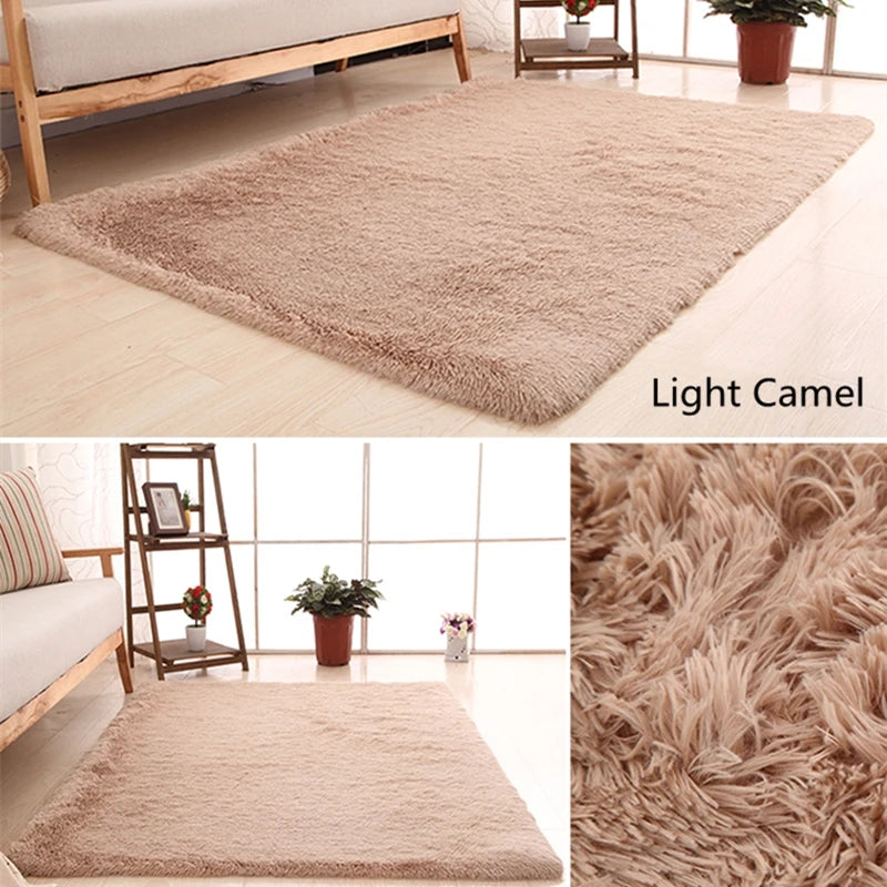 Light camel plush throw rug displayed on a wooden floor next to a bed and shelving unit.