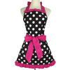A black polka dot ruffle apron with pink ribbon ties displayed on a mannequin.
