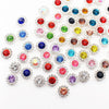 A collection of colorful crystal rhinestone sew-on buttons in various shades including red, blue, green, yellow, and clear.