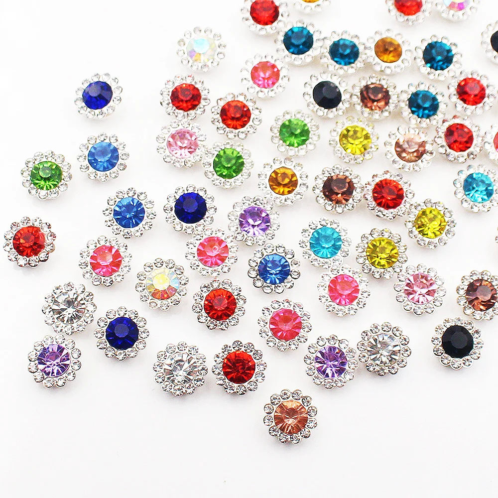 A collection of colorful crystal rhinestone sew-on buttons in various shades including red, blue, green, yellow, and clear.