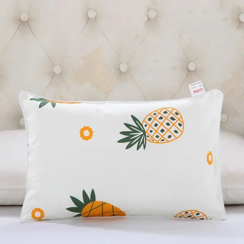 A white pillowcase featuring an orange pineapple and small orange flowers in a cartoon style.