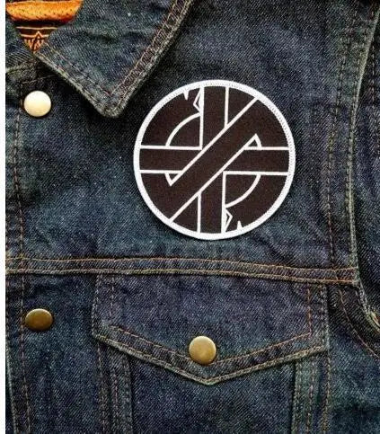 A close-up of a dark denim jacket featuring an embroidered Valknut Viking patch on the chest pocket.