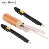 A set of fabric marking chalk pens with orange and beige colored tips and black handles.