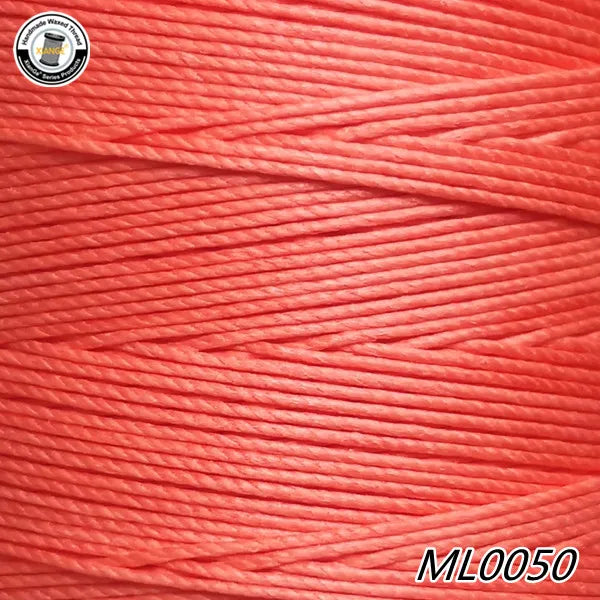 A close-up view of bright red embroidery thread or cord, showing the fine fibers and texture.