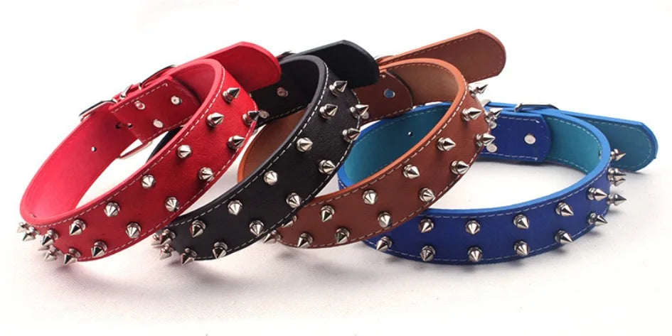 A collection of leather wristbands in various colors, including red, black, brown, and blue, featuring studs and spikes.