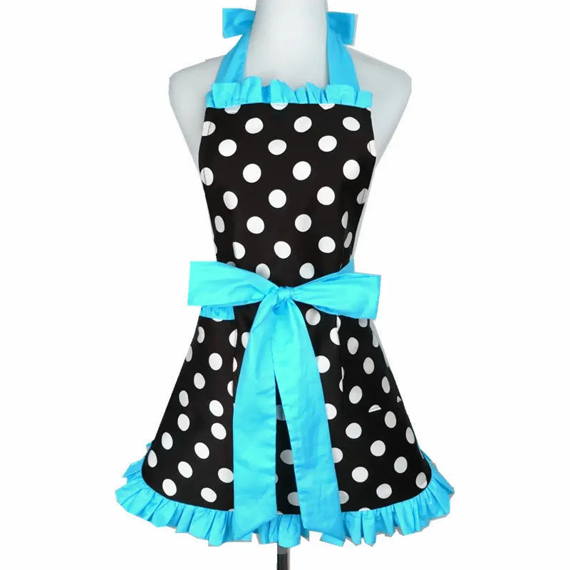 A black polka dot ruffle apron with light blue trim and a bow displayed on a mannequin.