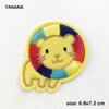 Yellow embroidered lion face patch with multicolored mane and outline