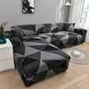 L-shaped sofa protector covers in black and gray geometric pattern on a modern sofa.