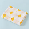 A soft cotton muslin swaddle blanket featuring a pattern of yellow chicks on a light background.