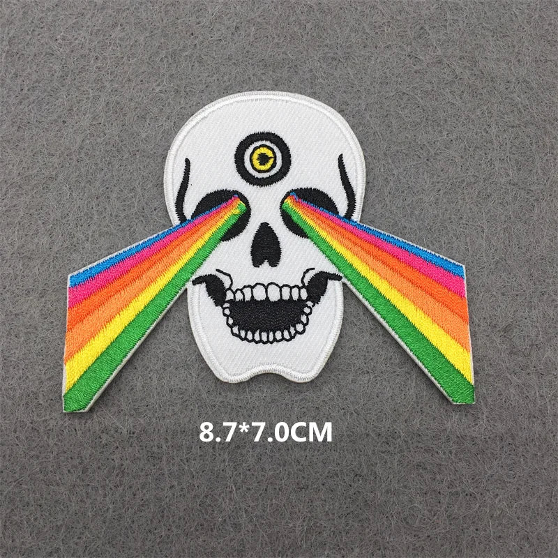 White skull design with a rainbow arching across the eyes on an iron-on patch