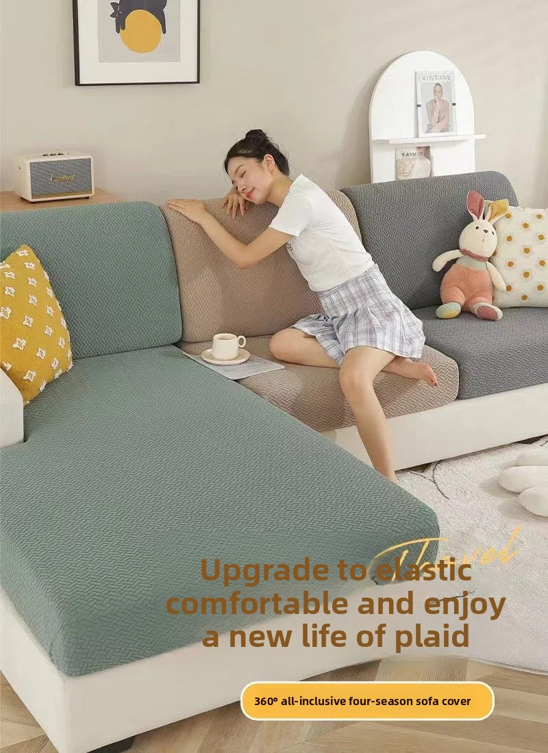 A woman relaxing on a gray sofa covered with a green cushion protector, demonstrating the comfortable fit of the durable sofa