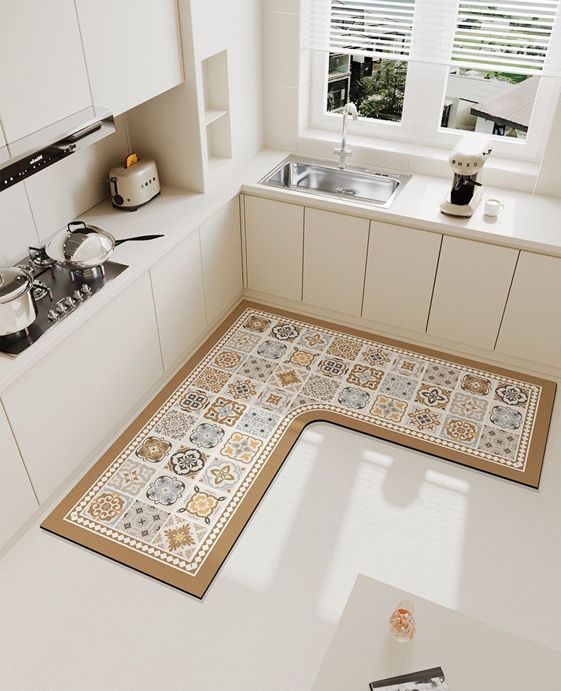 A luxury velvet anti-slip floor mat with intricate geometric patterns rests on a light-colored kitchen floor.