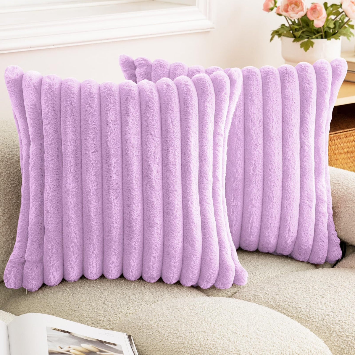 A fluffy lavender faux rabbit fur cushion cover resting on a light-colored sofa.