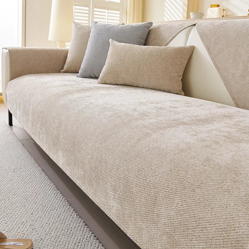 A beige chenille sofa cushion cover with gray accent pillows on a light-colored sofa.