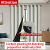 White blackout curtains hanging on a rod, demonstrating light-blocking properties.