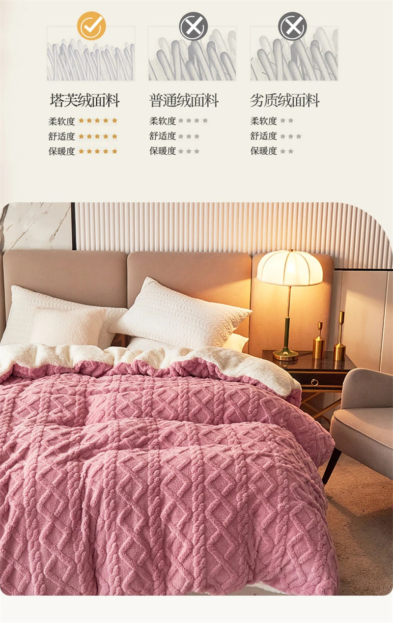 A pink quilted fleece blanket is displayed on a bed with white pillows and a bedside lamp.