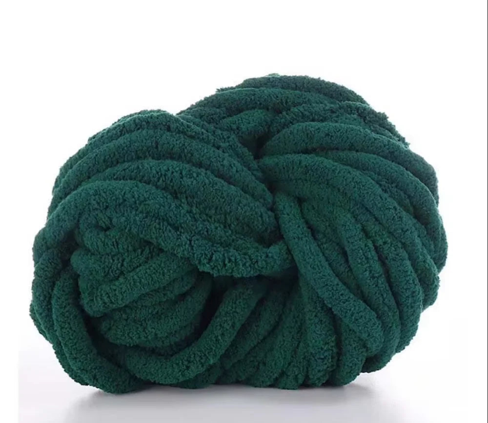 A ball of dark green hand-woven chunky chenille yarn.