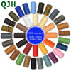 A collection of various colored waxed thread spools and rolls for leather and crafting projects.