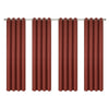 Set of four terracotta colored linen textured blackout curtains hanging on a rod