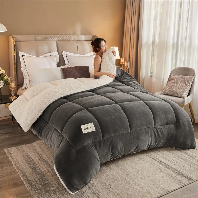 A person relaxing on a gray weighted fleece blanket in a bedroom with sheer curtains and soft lighting.