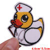 An embroidered patch depicting a yellow duck wearing a nurse's cap and holding a stick.
