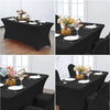 Black stretch tablecloth set for dining and event decor featuring elegant floral centerpieces on a table.