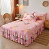 Pink double layer printed bed skirt with floral patterns on a bed.