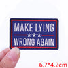 A dark blue embroidered patch with red and white text that reads MAKE LYING WRONG AGAIN