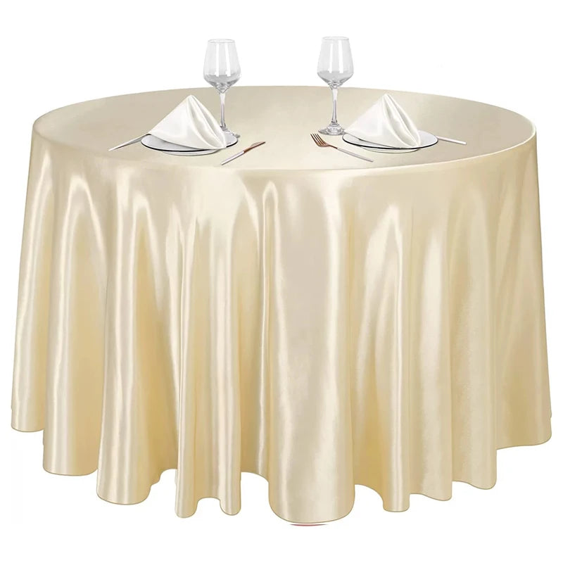 Elegant satin gold round tablecloth set with glassware and silverware for events