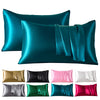 A set of six satin pillowcases in various shades of teal, green, pink, and purple.