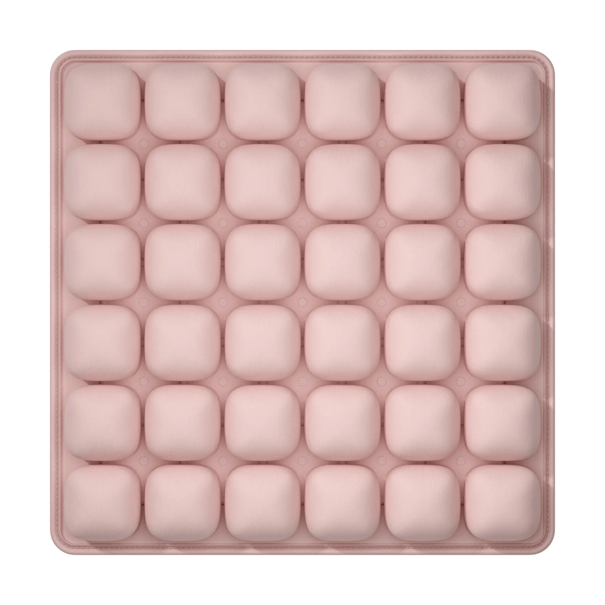 A pink, square seat cushion with multiple individual compartments for adjustable pressure relief.