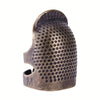 A vintage antique sewing thimble and needle protector set made of dark metal with a textured surface.