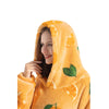 A woman wearing an orange and green patterned sherpa fleece oversized blanket hoodie.
