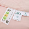 A white ice silk cooling comforter product package is shown on a pink background.