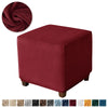 A deep burgundy velvet ottoman slipcover protecting furniture.