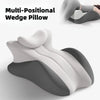 A multi-positional wedge pillow in gray and white, shown from a side view.