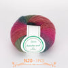 A ball of multi-colored wool yarn featuring shades of pink, green, and burgundy.