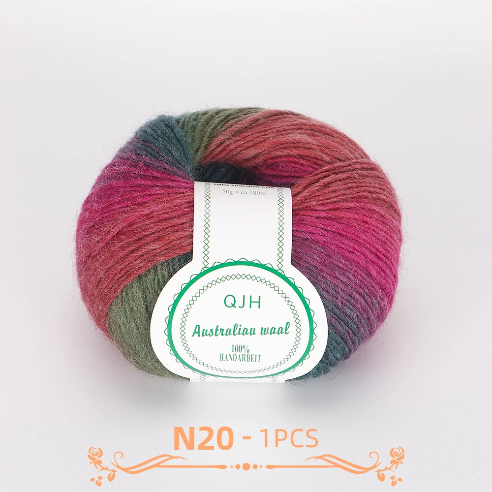 A ball of multi-colored wool yarn featuring shades of pink, green, and burgundy.