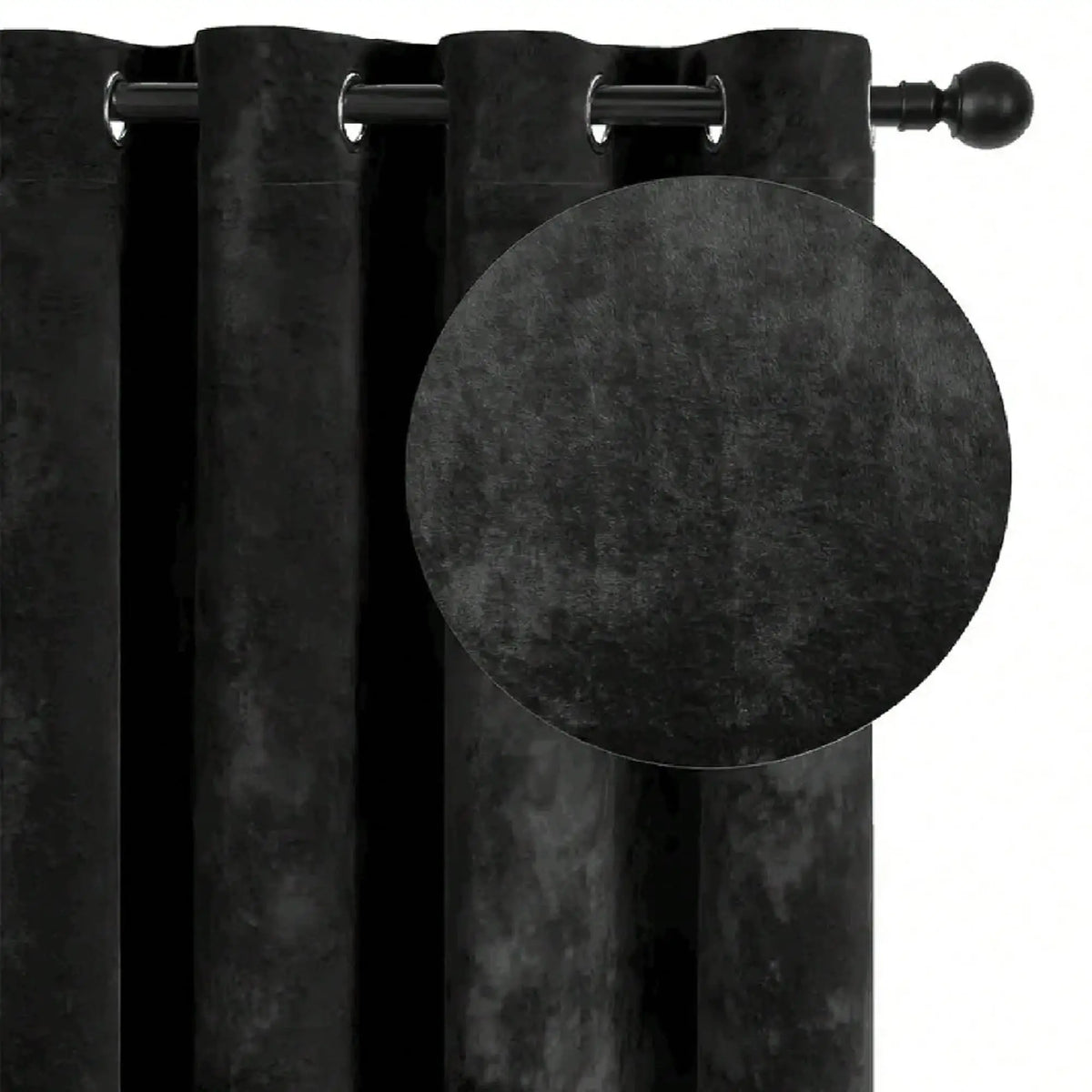 A close-up of a black velvet blackout curtain hanging on a rod.