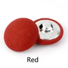 A single round red fabric-covered shank button with a silver metal shank visible.