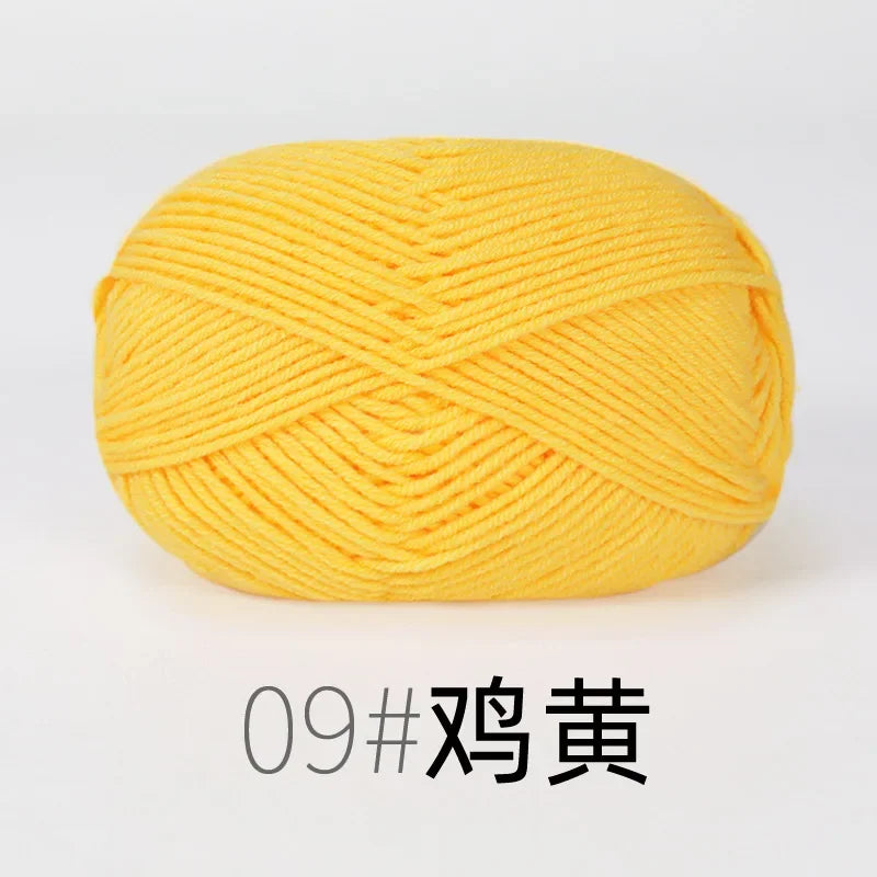 A ball of bright yellow organic cotton 4ply knitting yarn.