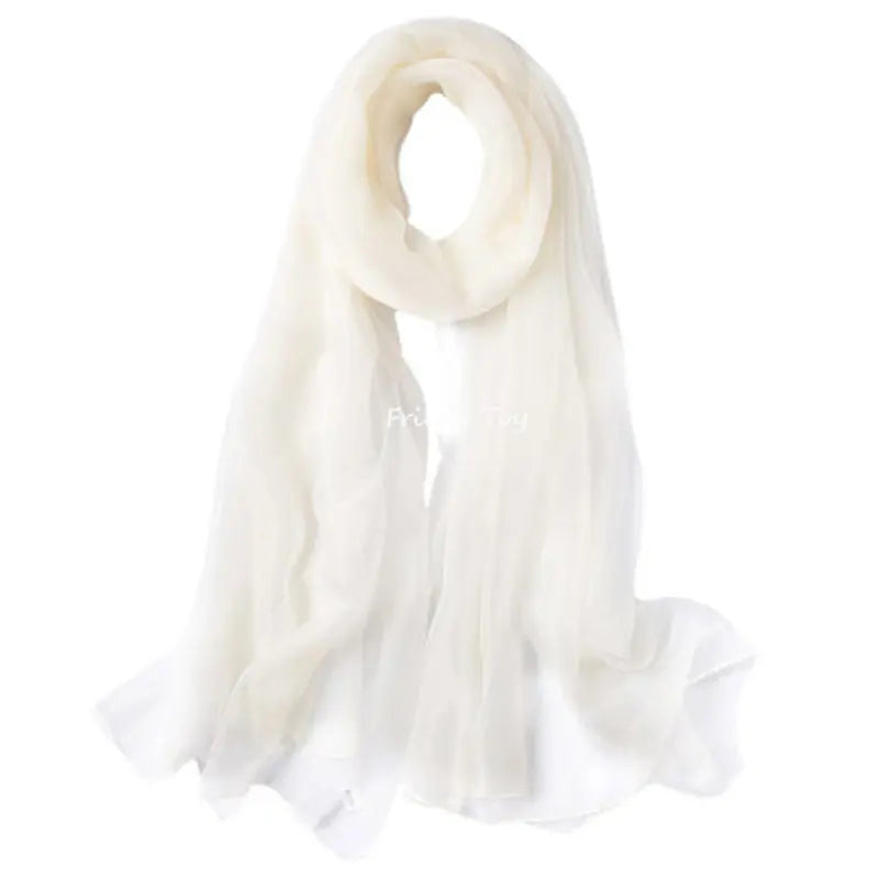 A flowing, sheer white scarf used for sensory play by toddlers.