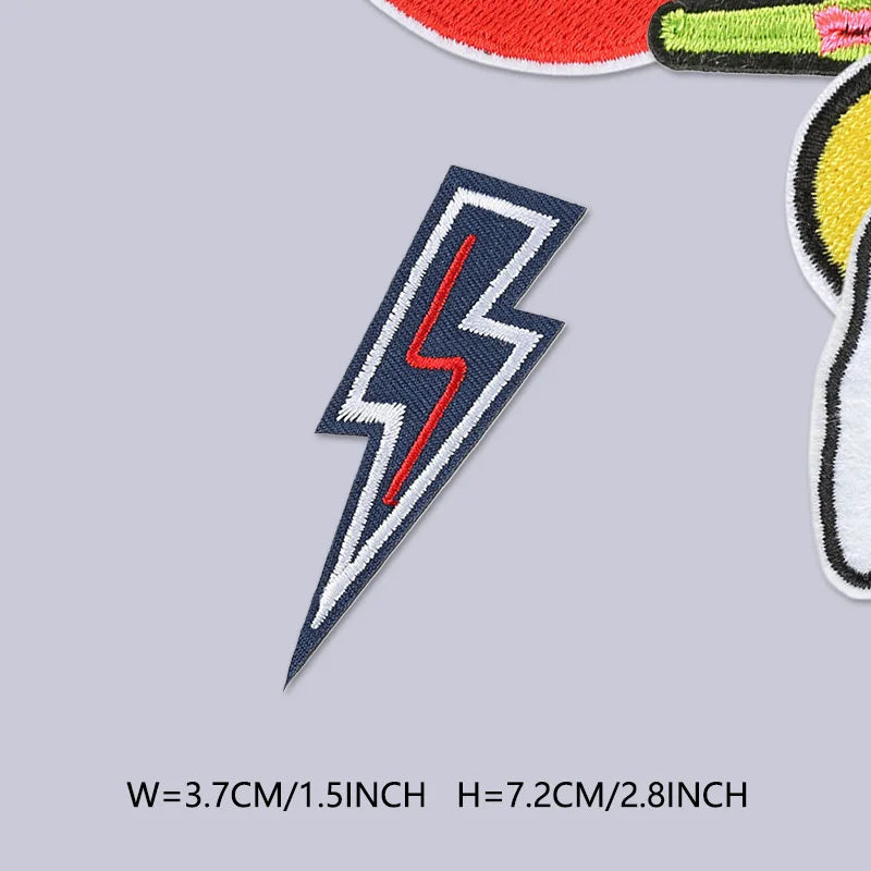 A close-up view of a blue lightning bolt embroidered patch on a gray background.