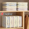 Four sets of foldable bed sheet storage bags with light and pastel patterns displayed on a wooden shelf.